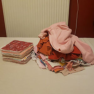 two differently cut piles of baby clothes