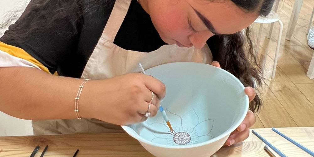 Latifa doing some pottery painting